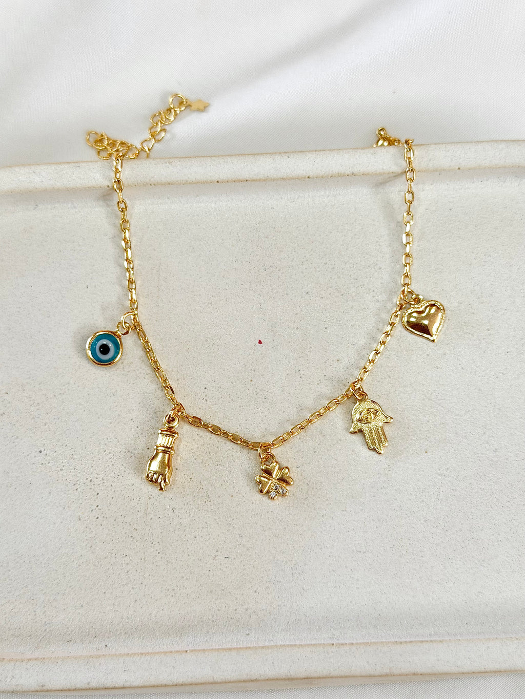 Pulseira mão de Fátima, figa e olho grego