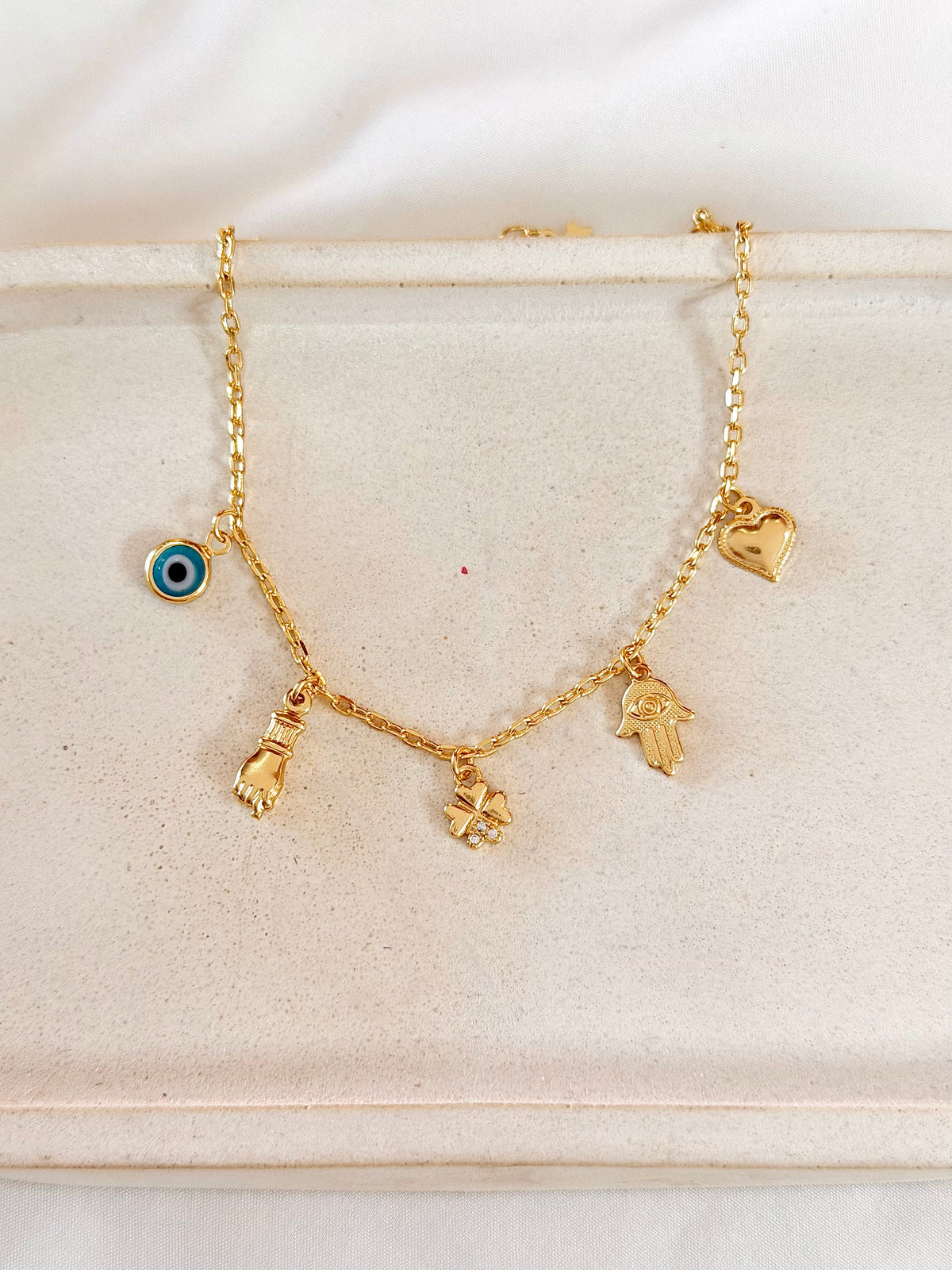 Pulseira mão de Fátima, figa e olho grego
