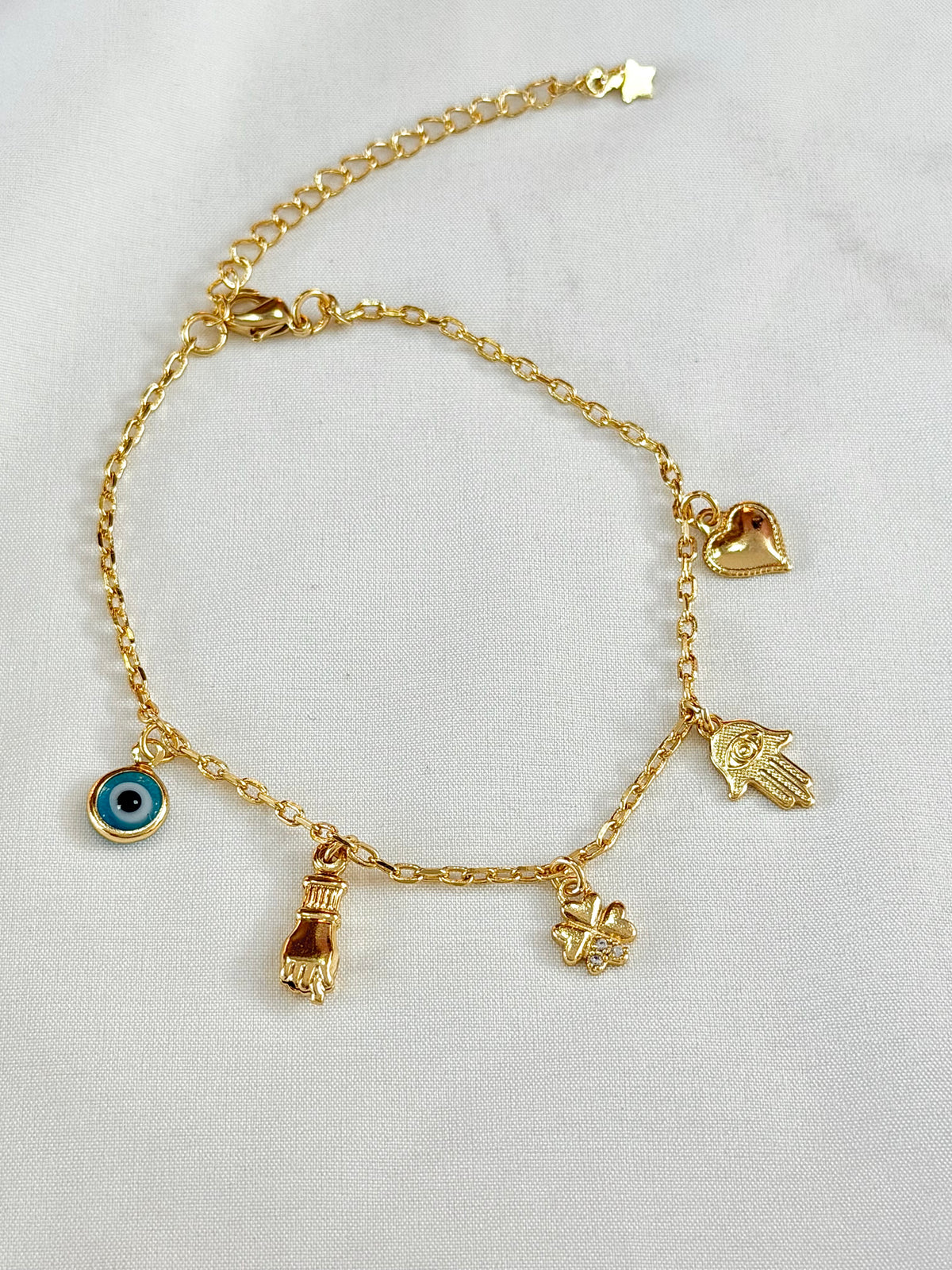 Pulseira mão de Fátima, figa e olho grego