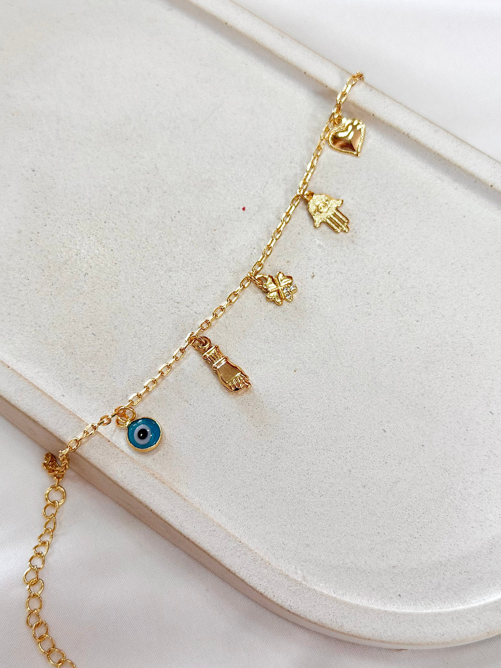 Pulseira mão de Fátima, figa e olho grego