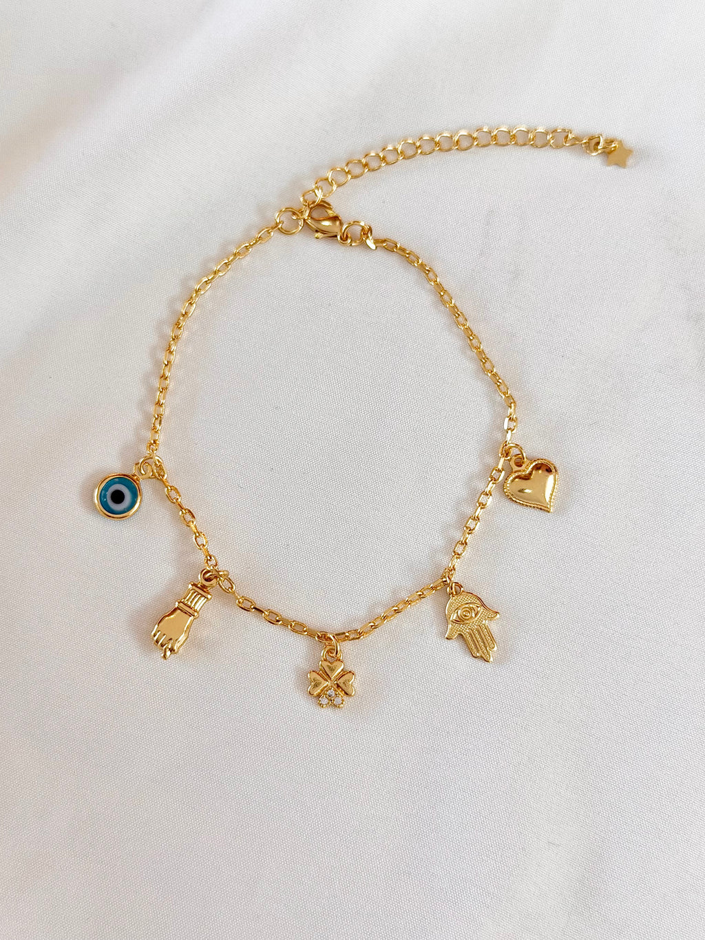 Pulseira mão de Fátima, figa e olho grego